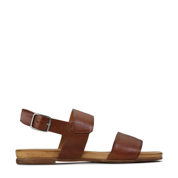 Eos Dana Brandy  Conjuring the timeless tranquillity of summers past, present, and future, Dana is a paradigm design that stands the test of time. With two smooth straps and a slingback around the ankle, the style is finished with an unfussy rectangular metal buckle. Everything you want to see in a pair of quality women’s sandals. Available at www.ivyandgrace.com.au
