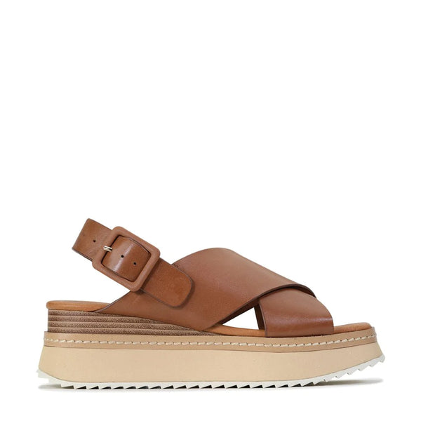 There are few other shoes that will slip so effortlessly into your warm weather rotations. Tonalities is a pair of leather platform sandals with endless adaptability, suitable for summer occasions day and night. The classic crossover style is paired with leather buckles and a luxuriously padded footbed, complete with beautiful open stitching and an organic demi wedge.